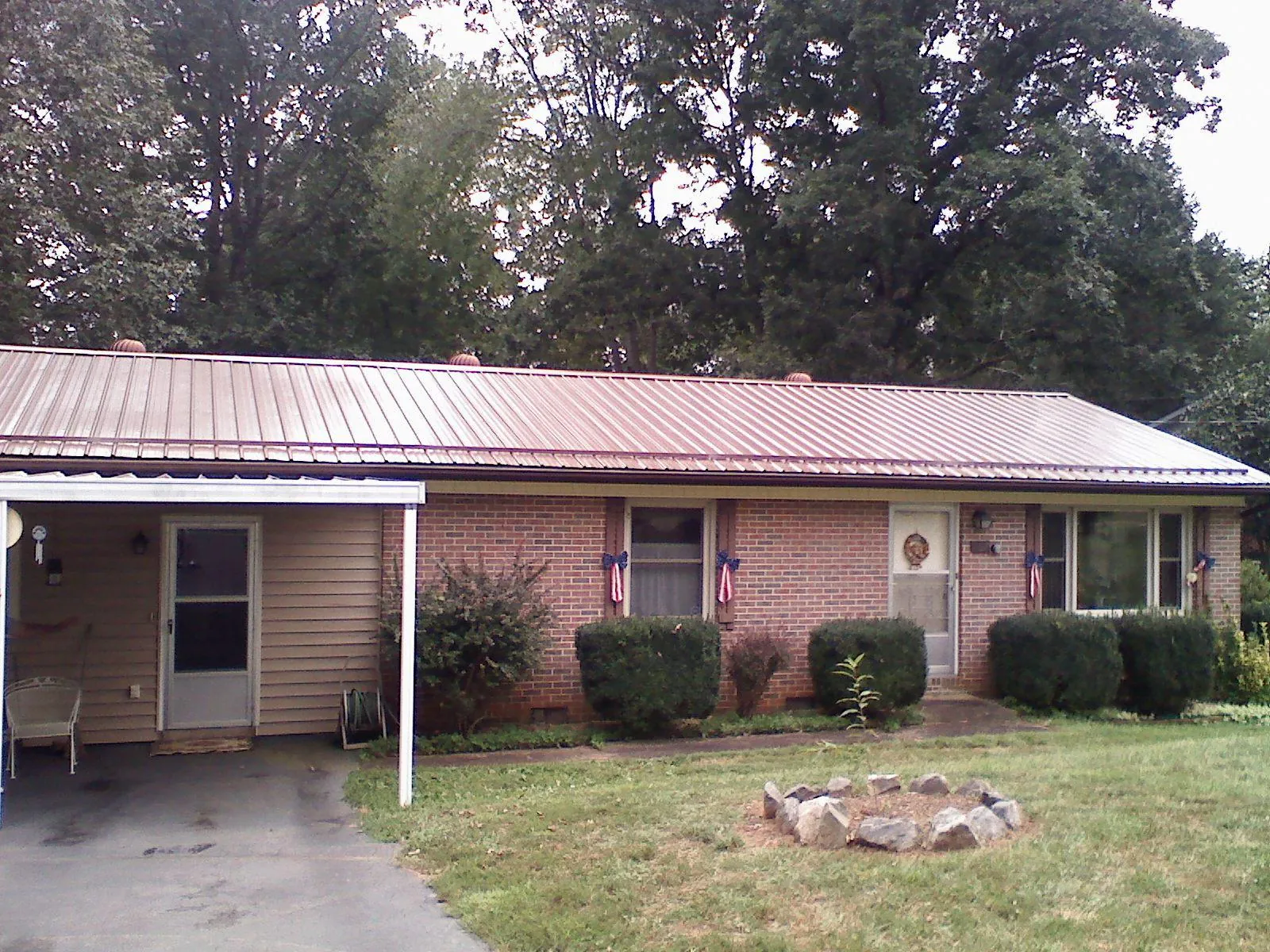 Bronze metal roof and carport on a brick ranch home — Roof Repair work by our crew in Knightsen